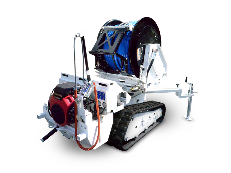 A white tracked machine with a large blue cable spool and red engine for utility work.